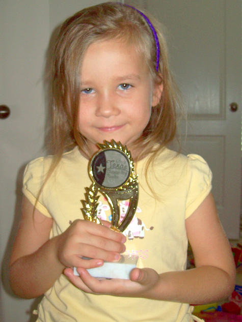 On Saturday, Corina won a reading trophy for her participation in the Summer Reading Program in the Fort Bend County library system. She's "read" 22 books so far. 