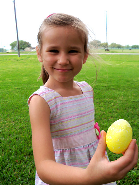 Corina holds a cracked polka-dotted egg.