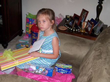 Corina opens presents.